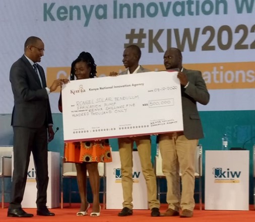 Principal Secretary for Youth Affairs awards Rongel Pump Innovators for emerging position 1 during Kenya Innovation Week, 5th-8th December, 2022 in Sarit Centre Nairobi
